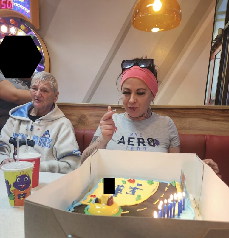 Murder suspect Desiree Linnette sits in front of birthday cake